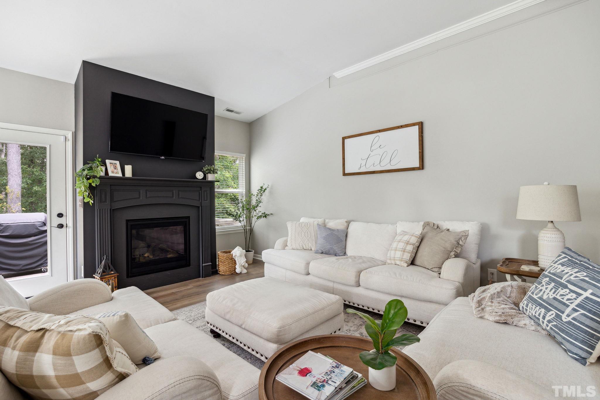 505 Miners Loop Sanford, NC 27330 - Photo 12 of 45 a living room with furniture a flat screen tv and a fireplace