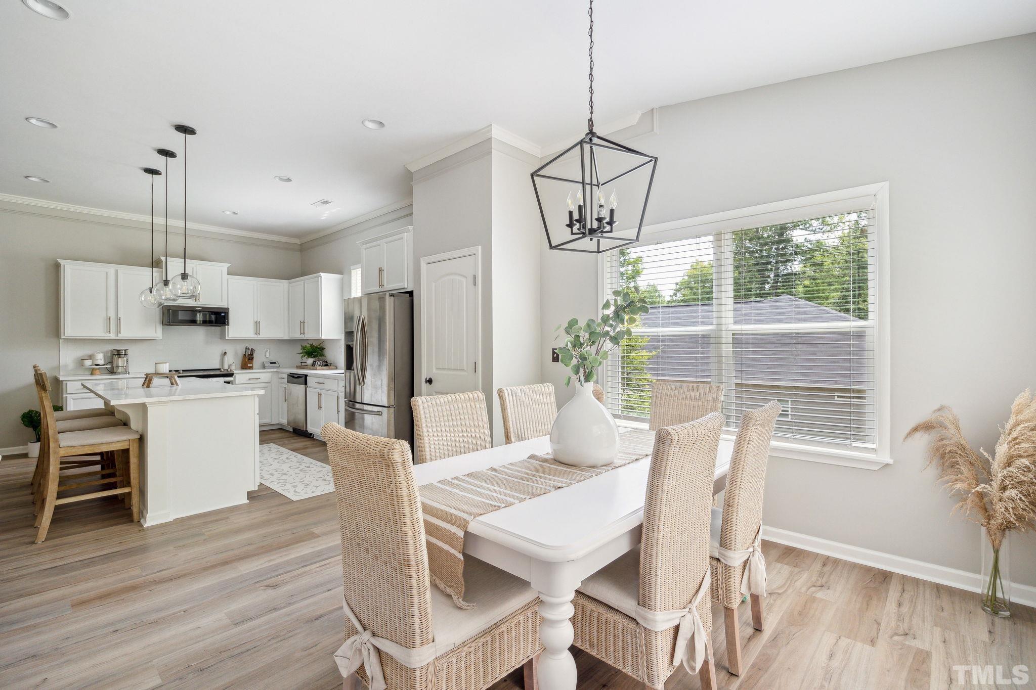 505 Miners Loop Sanford, NC 27330 - Photo 15 of 45 a view of a dining room and livingroom with furniture wooden floor a chandelier