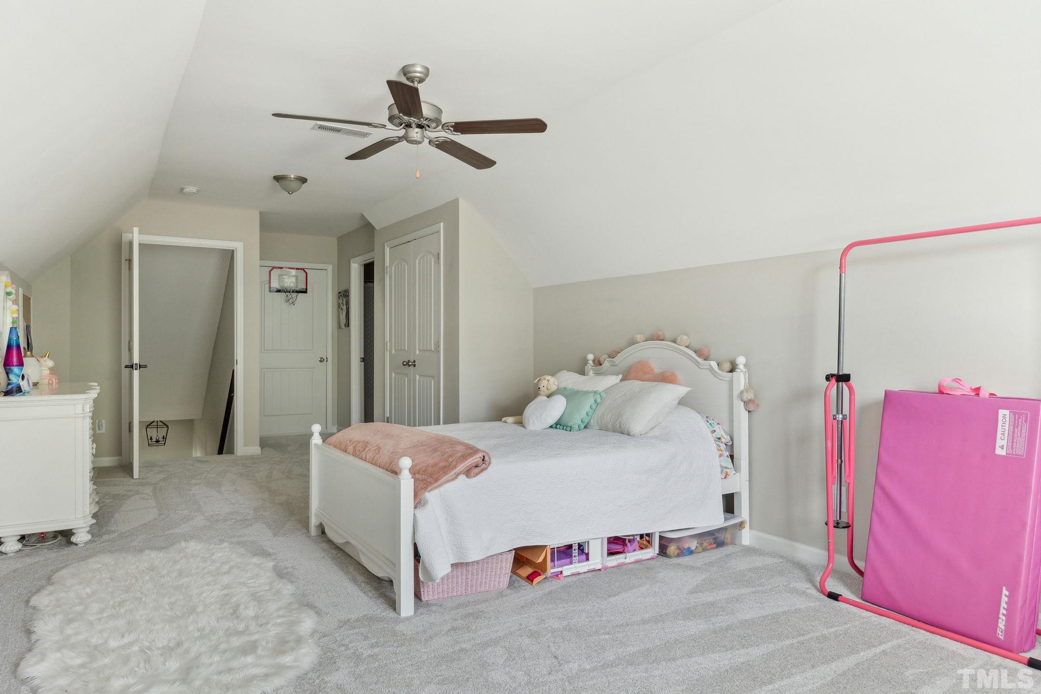 505 Miners Loop Sanford, NC 27330 - Photo 22 of 45 a bedroom with a bed and a chandelier