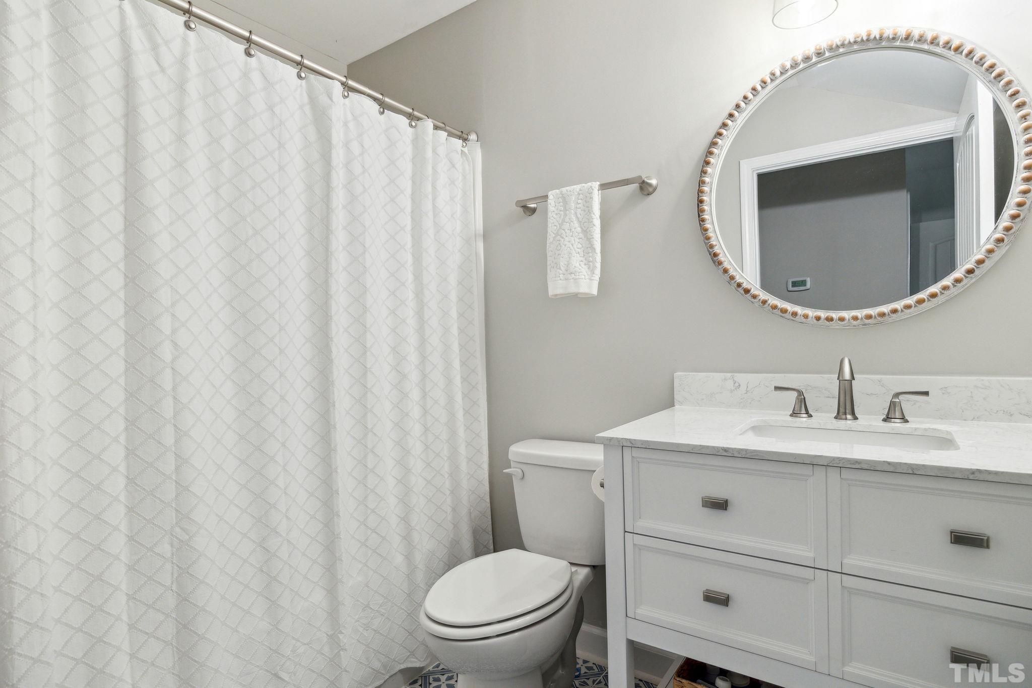 505 Miners Loop Sanford, NC 27330 - Photo 23 of 45 a bathroom with a toilet a sink and a mirror