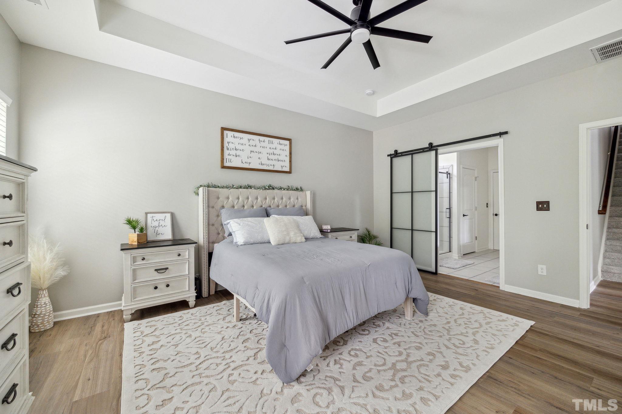 505 Miners Loop Sanford, NC 27330 - Photo 25 of 45 a bedroom with a bed and a chandelier