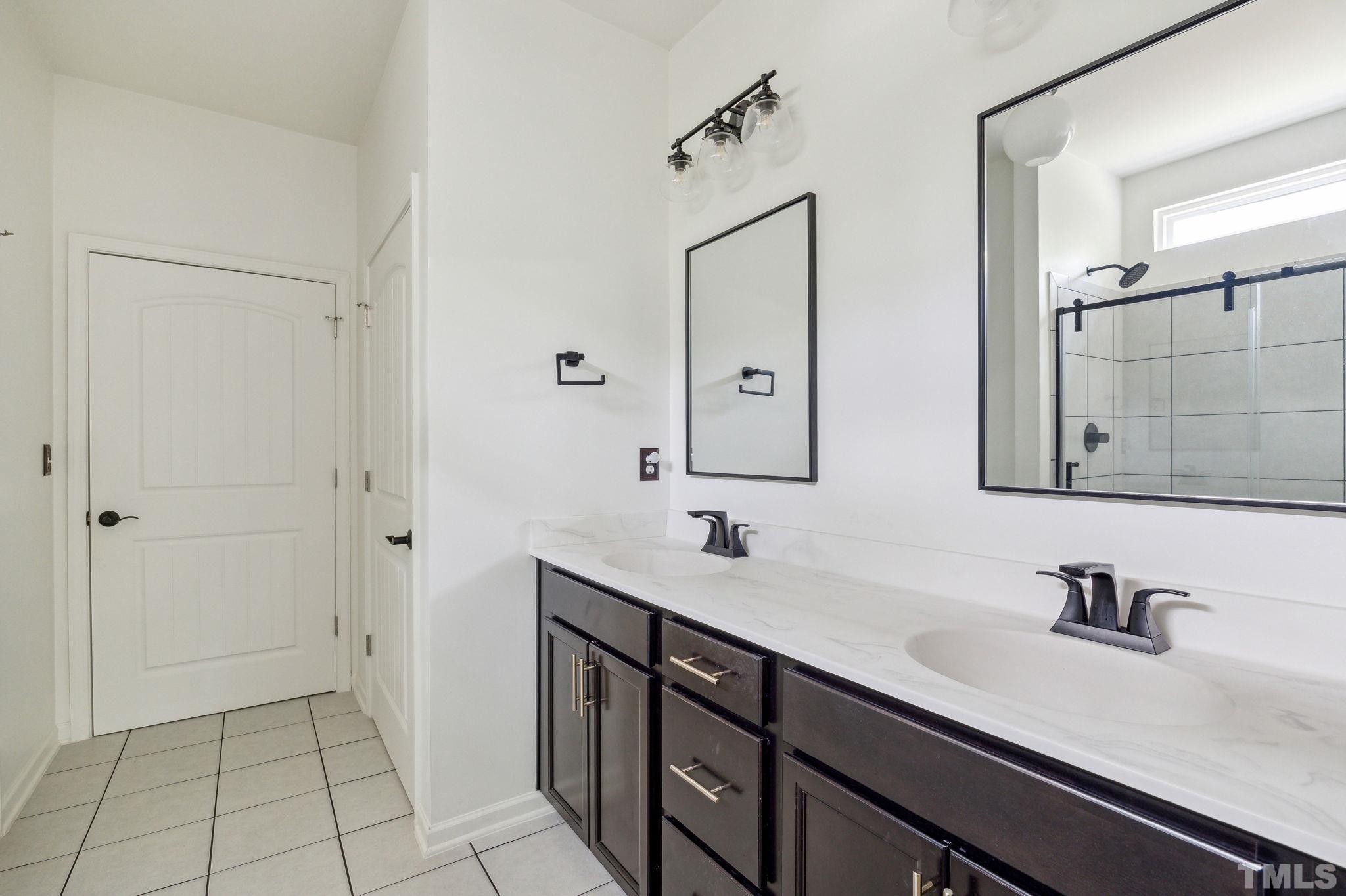 505 Miners Loop Sanford, NC 27330 - Photo 27 of 45 a bathroom with a sink and a mirror