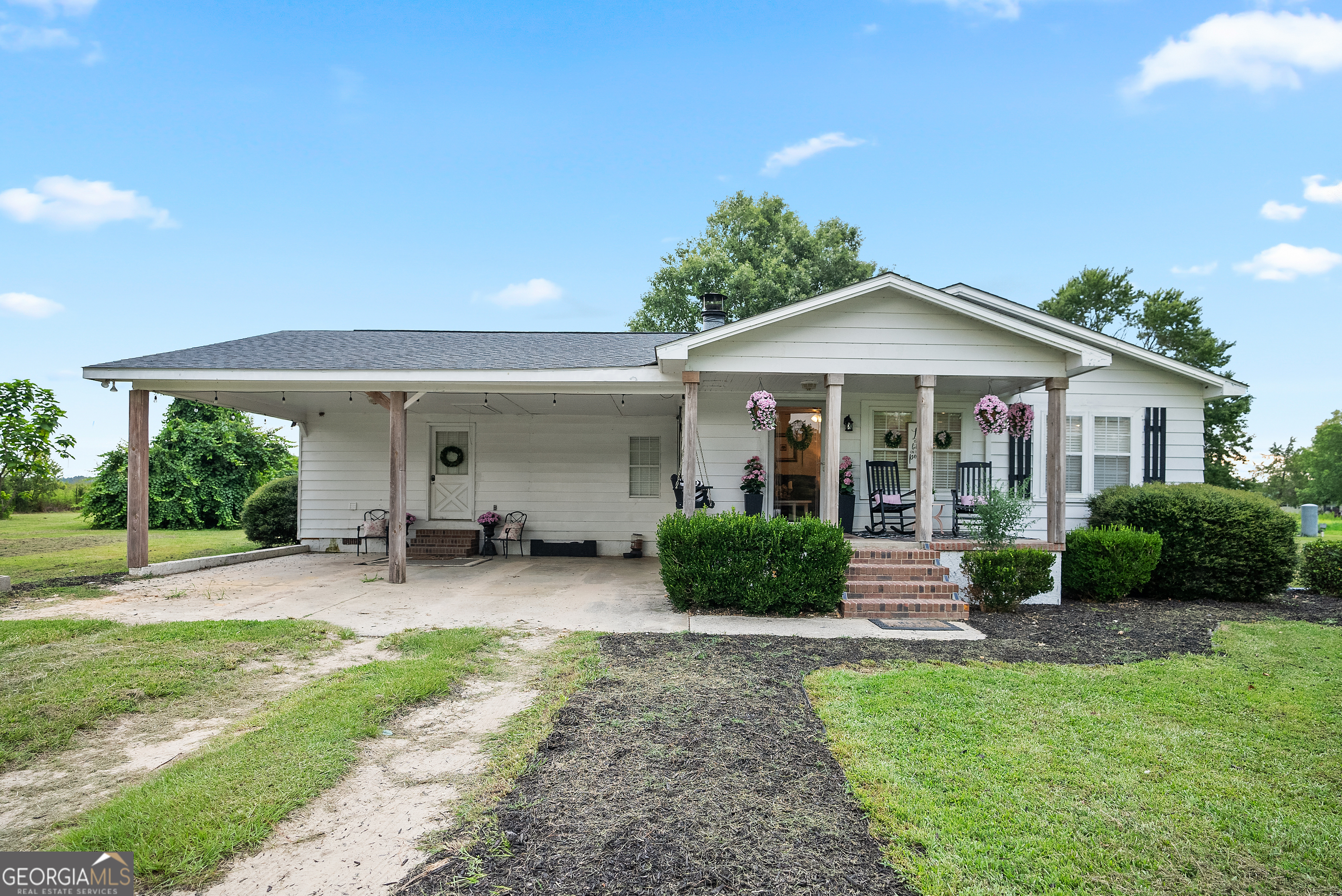 183 Moray Road Alma, GA 31510 - Photo 1 of 1 a front view of a house with garden and porch