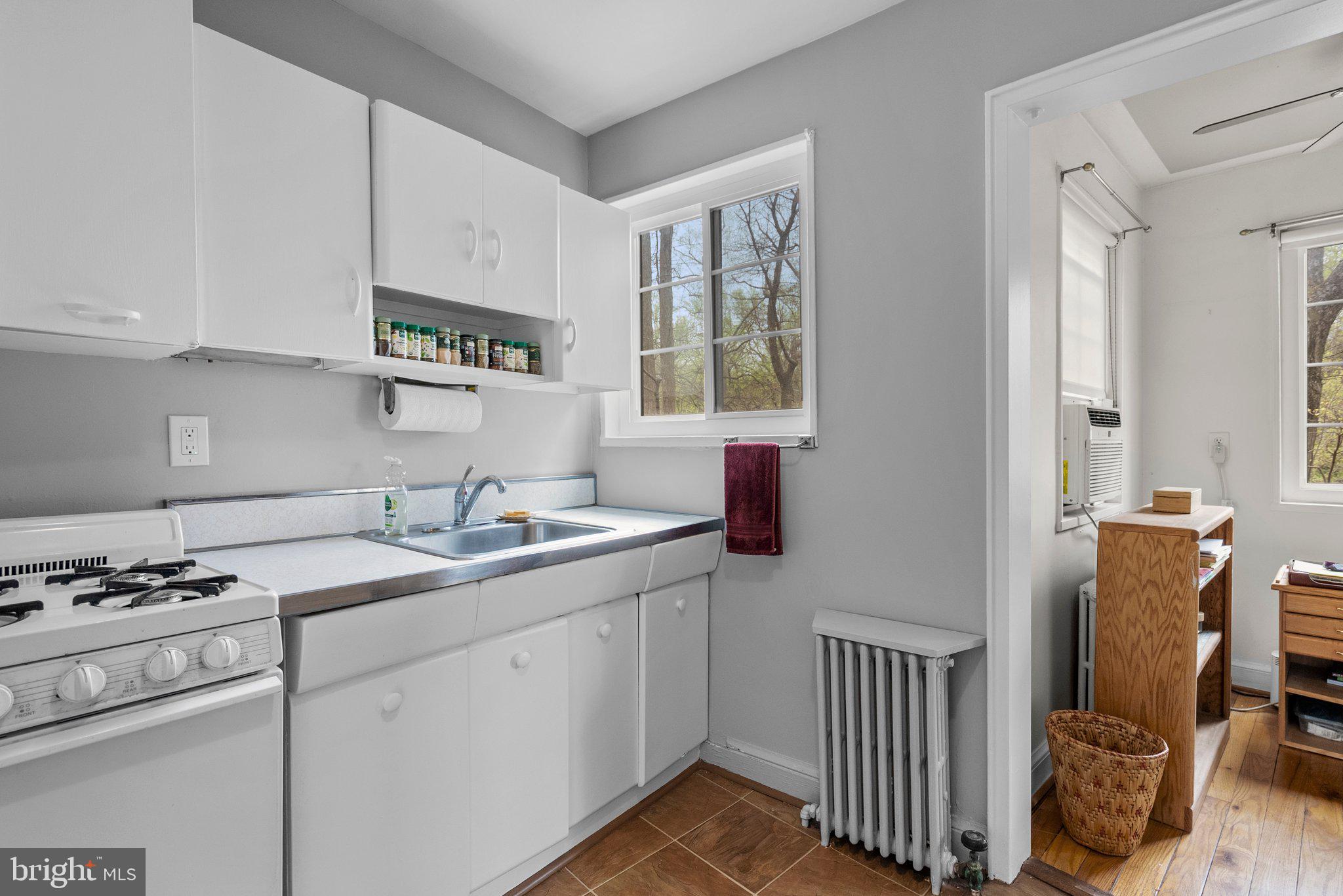8720 Manchester Road, Unit 4 Silver Spring, MD 20901 - Photo 11 of 28 a kitchen with a sink cabinets and window