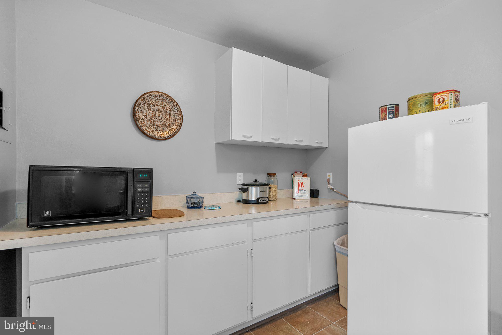 8720 Manchester Road, Unit 4 Silver Spring, MD 20901 - Photo 12 of 28 a kitchen with stainless steel appliances a refrigerator sink and microwave