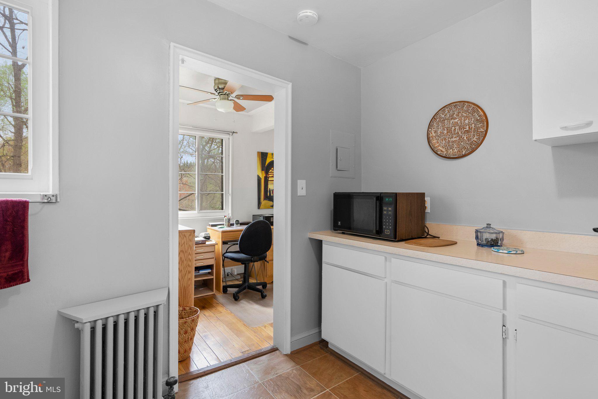 8720 Manchester Road, Unit 4 Silver Spring, MD 20901 - Photo 10 of 28 a living room with furniture and a flat screen tv