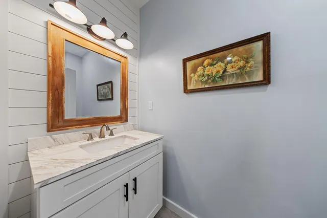 a bathroom with a sink mirror and vanity