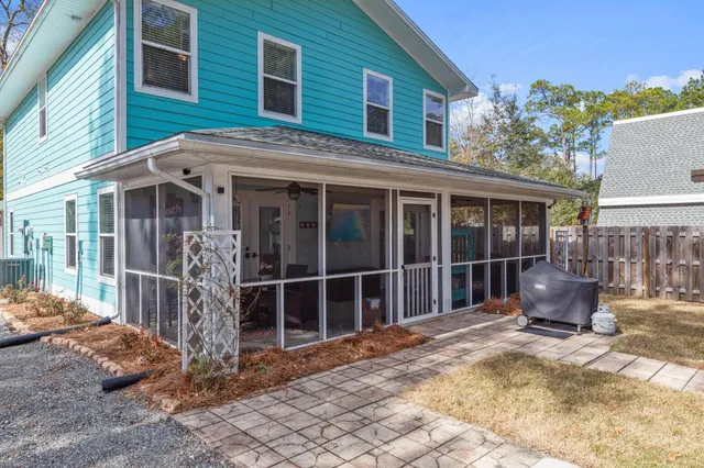 a view of a house with backyard porch and furniture