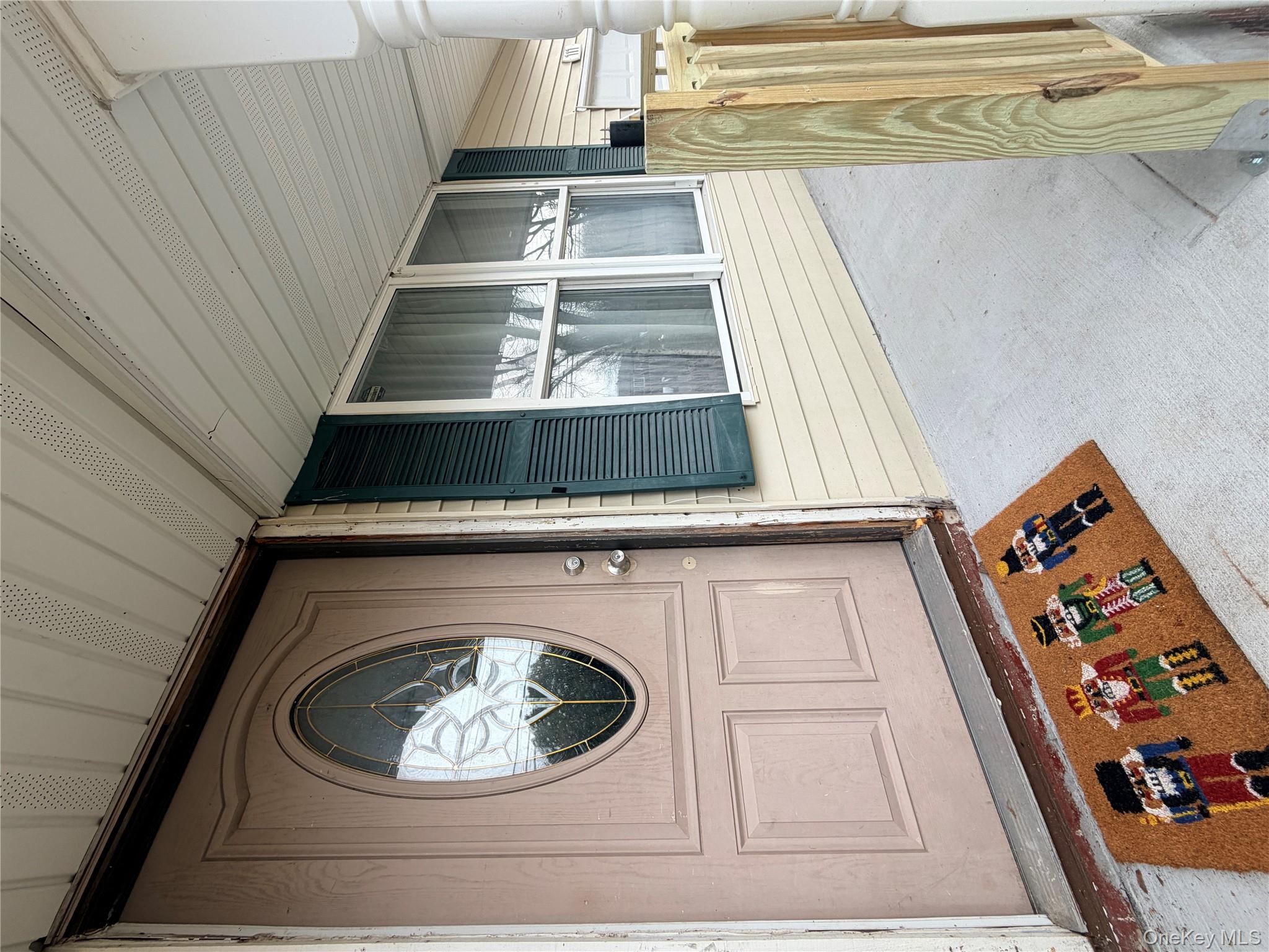 717 Doane Avenue Bellport, NY 11713 - Photo 1 of 12 a front view of a house with a large window