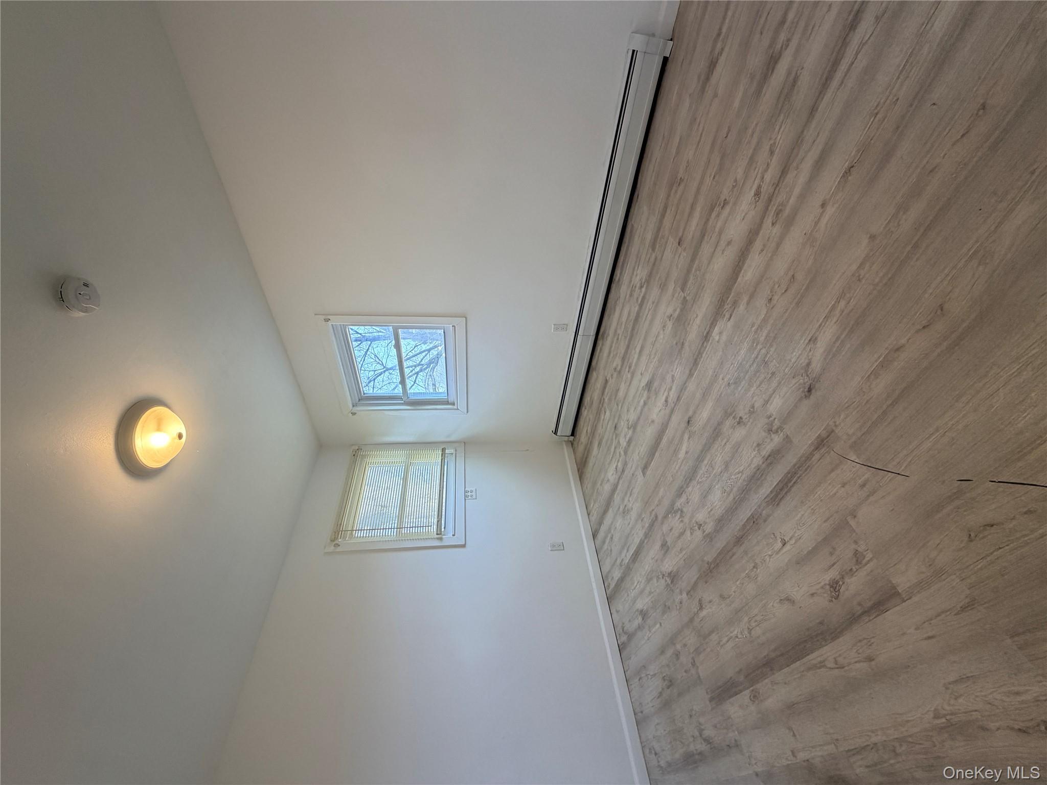 717 Doane Avenue Bellport, NY 11713 - Photo 11 of 12 a view of empty room with wooden floor and fan