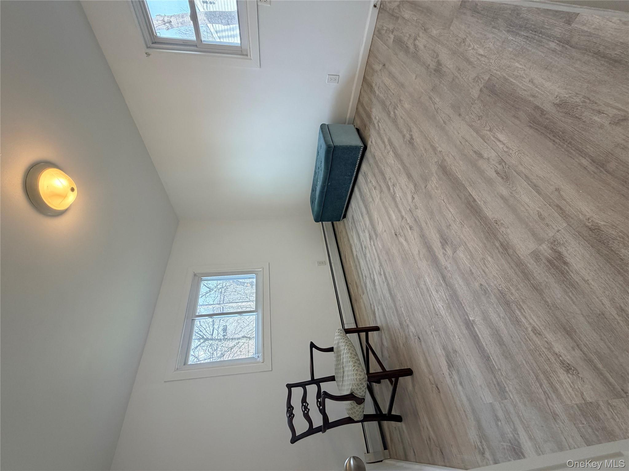 717 Doane Avenue Bellport, NY 11713 - Photo 12 of 12 a view of a room with wooden floor and lounge chair