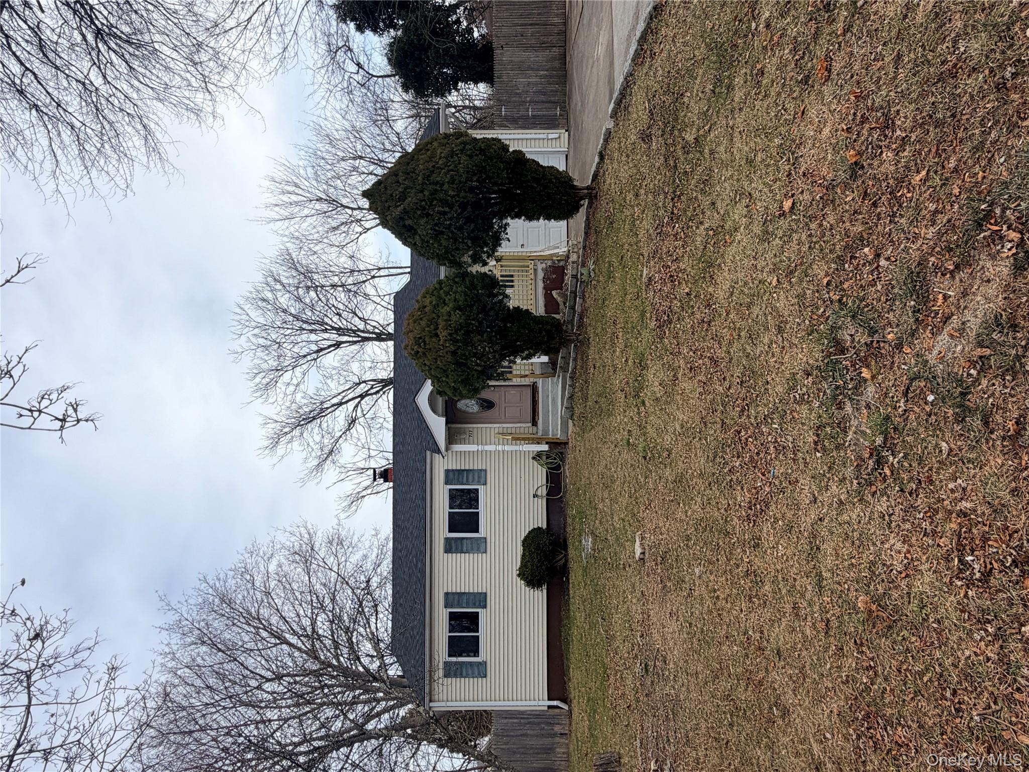 717 Doane Avenue Bellport, NY 11713 - Photo 4 of 12 a view of a house with backyard and sitting area