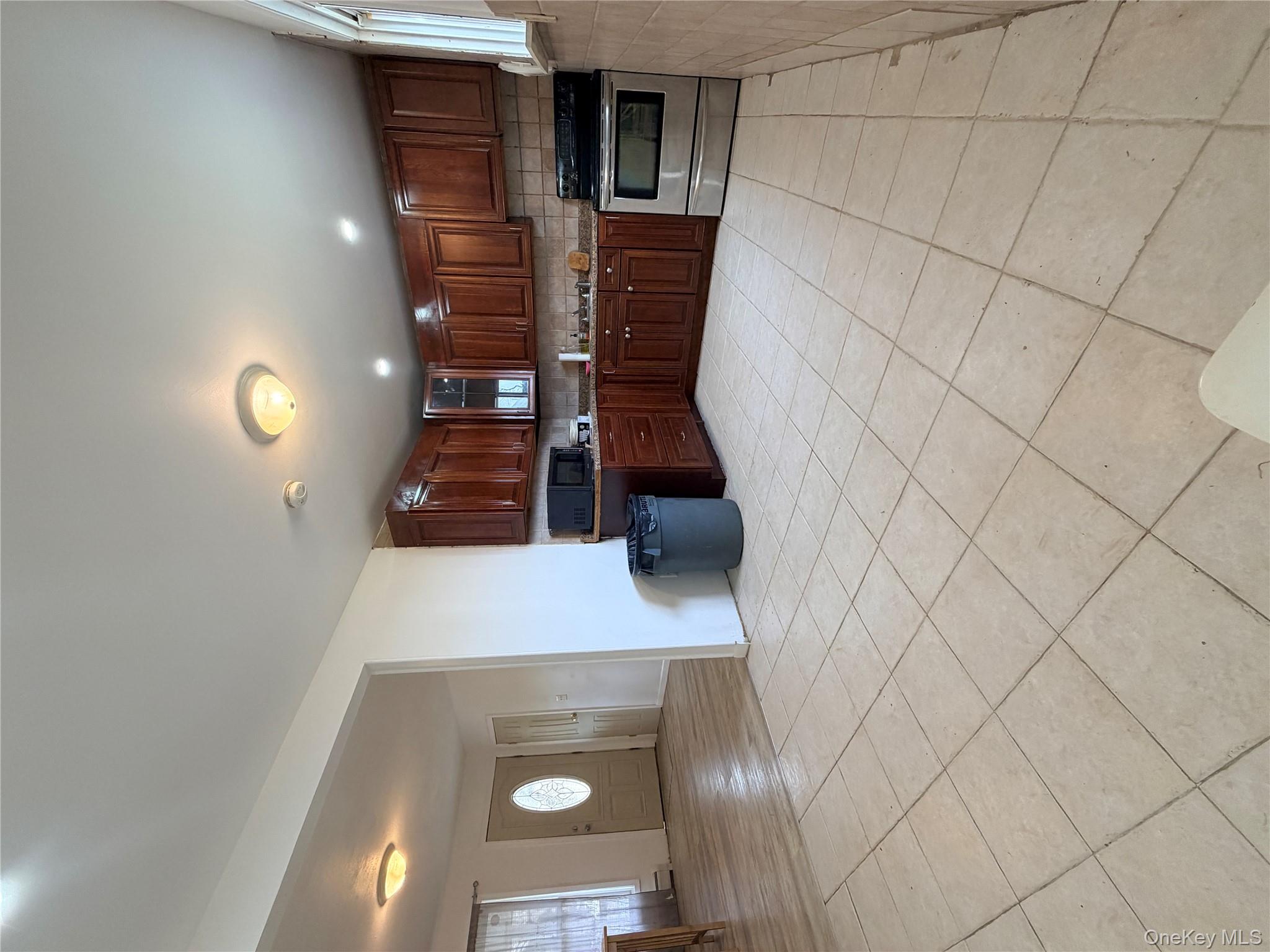 717 Doane Avenue Bellport, NY 11713 - Photo 6 of 12 a kitchen with kitchen island granite countertop a stove top oven a sink a counter top space and cabinets