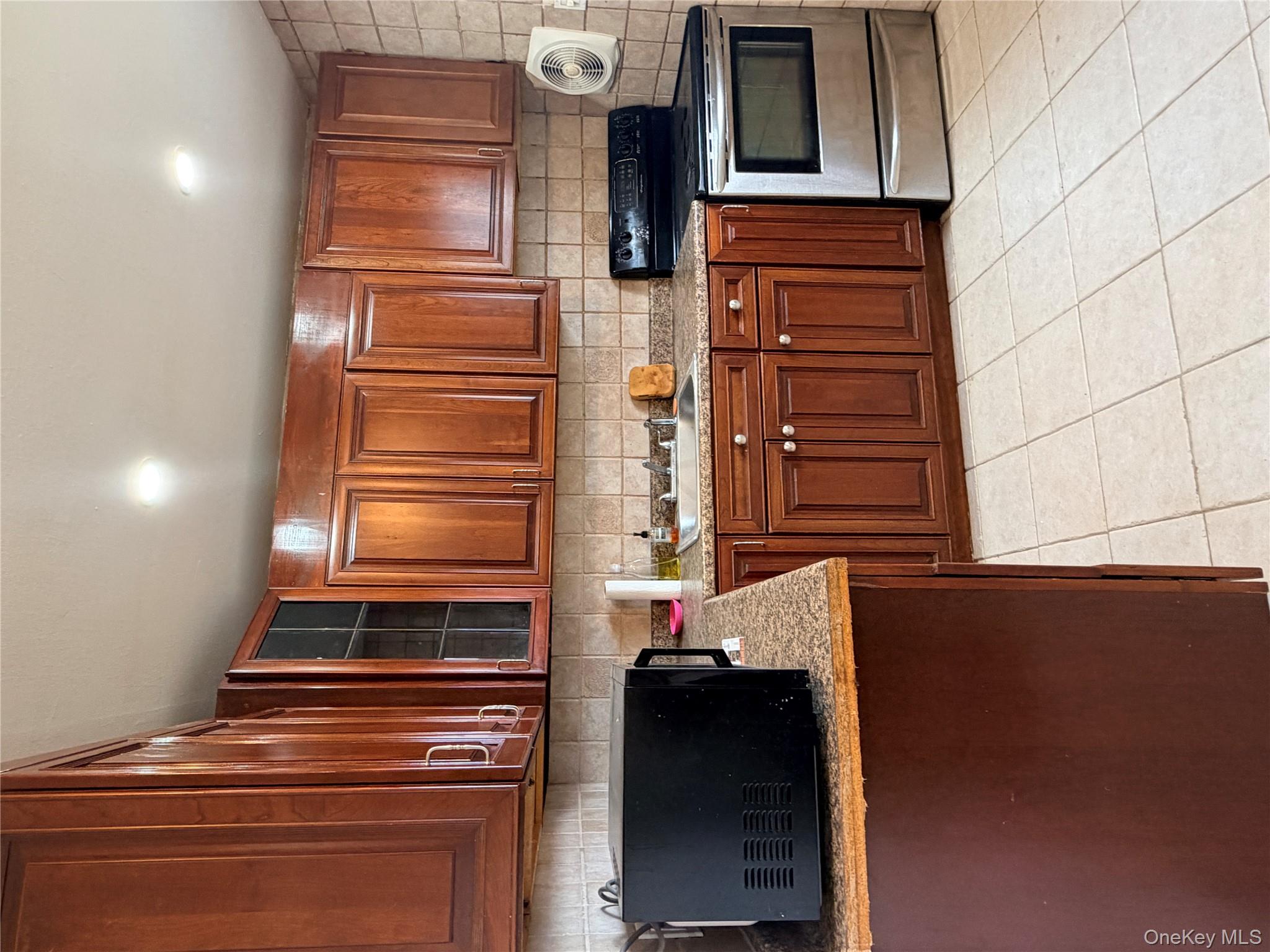 717 Doane Avenue Bellport, NY 11713 - Photo 7 of 12 a kitchen with stainless steel appliances granite countertop a stove a sink and a microwave