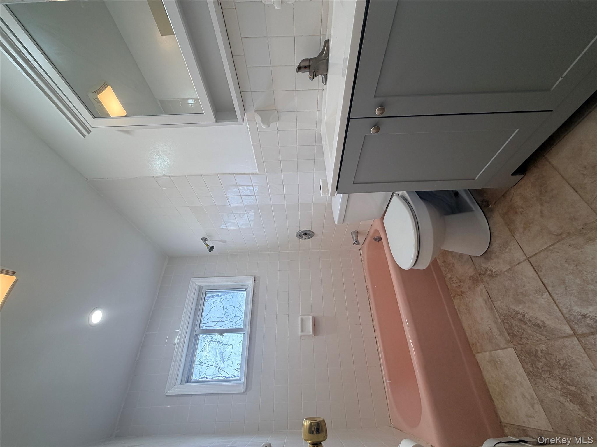 717 Doane Avenue Bellport, NY 11713 - Photo 10 of 12 a bathroom with a toilet sink and mirror