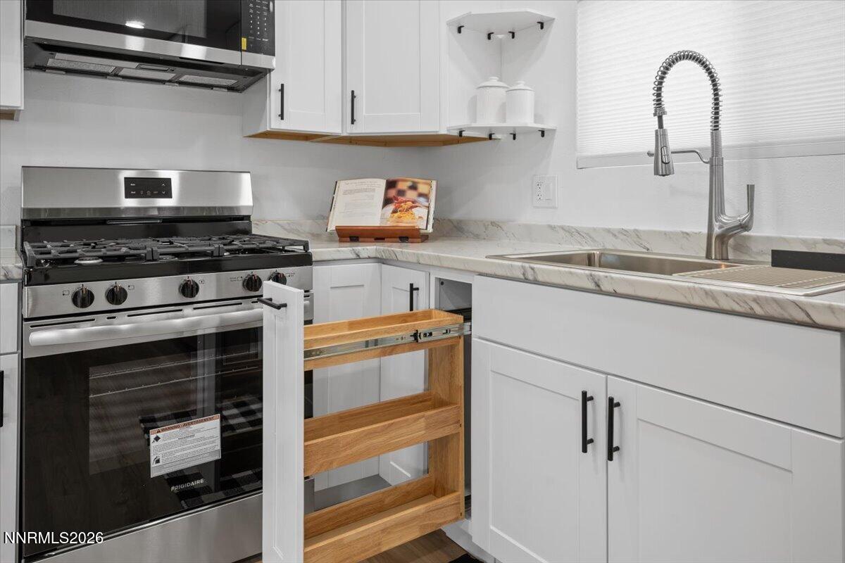 384 Loster Way Sun Valley, NV 89433 - Photo 14 of 35 a close view of a stove top oven and cabinets