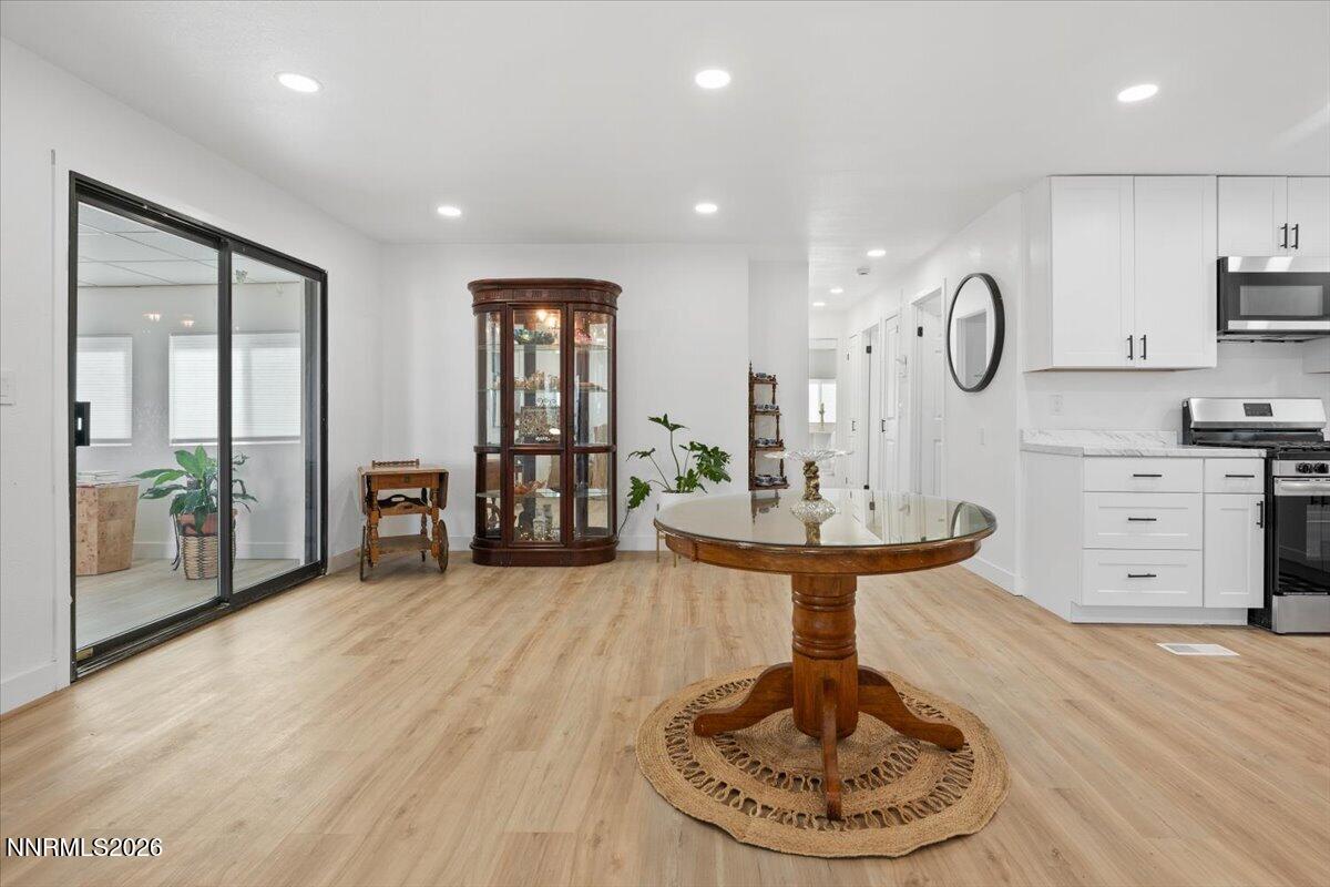 384 Loster Way Sun Valley, NV 89433 - Photo 15 of 35 a living room with kitchen island furniture and a wooden floor