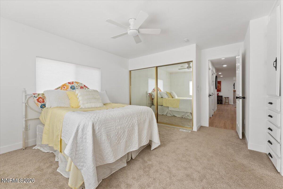 384 Loster Way Sun Valley, NV 89433 - Photo 18 of 35 a bedroom with a bed and a walk in closet