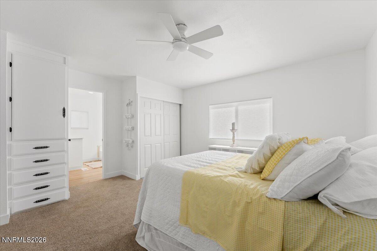 384 Loster Way Sun Valley, NV 89433 - Photo 19 of 35 a bedroom with a bed and a ceiling fan