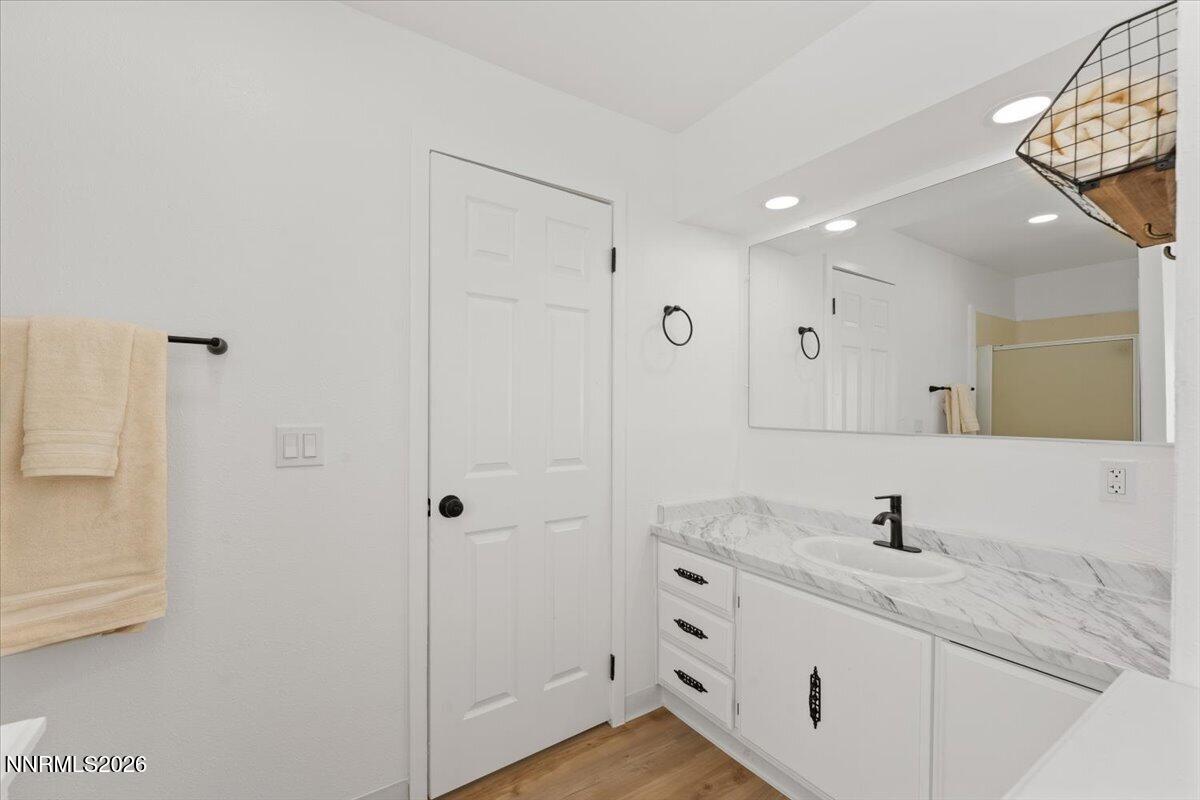 384 Loster Way Sun Valley, NV 89433 - Photo 21 of 35 a bathroom with a double vanity sink and mirror