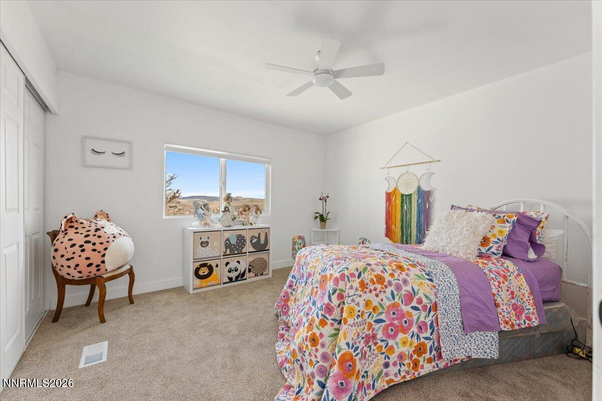 384 Loster Way Sun Valley, NV 89433 - Photo 22 of 35 a bedroom with a bed and a cabinets