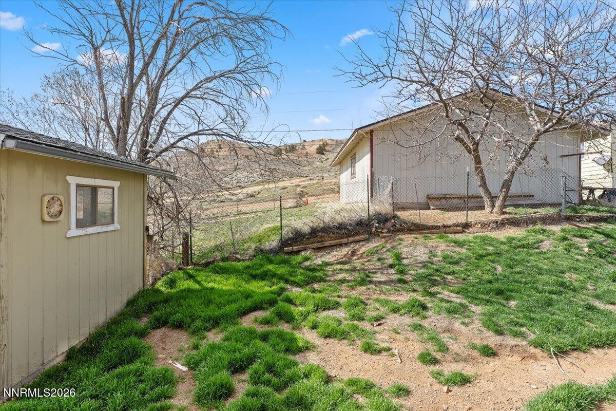 384 Loster Way Sun Valley, NV 89433 - Photo 28 of 35 a backyard of a house with lots of green space and fountain