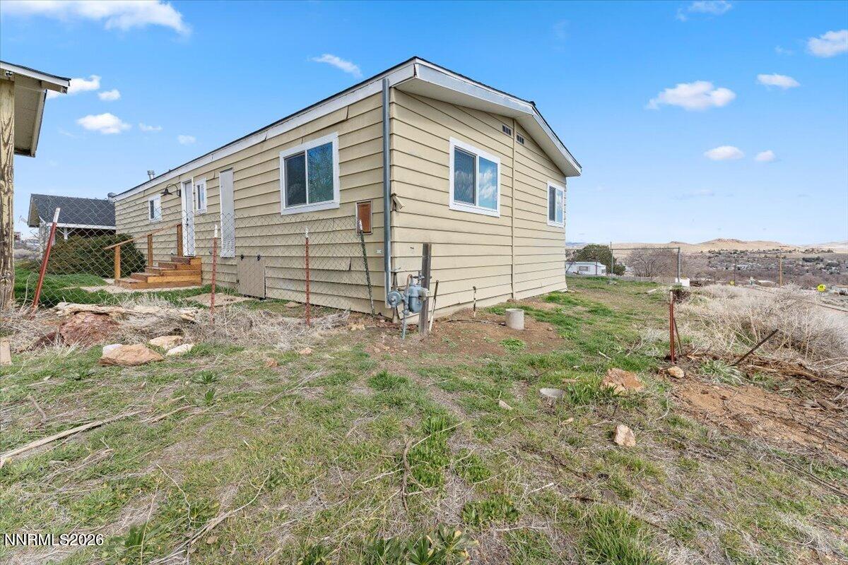 384 Loster Way Sun Valley, NV 89433 - Photo 30 of 35 a view of backyard of house and car parked