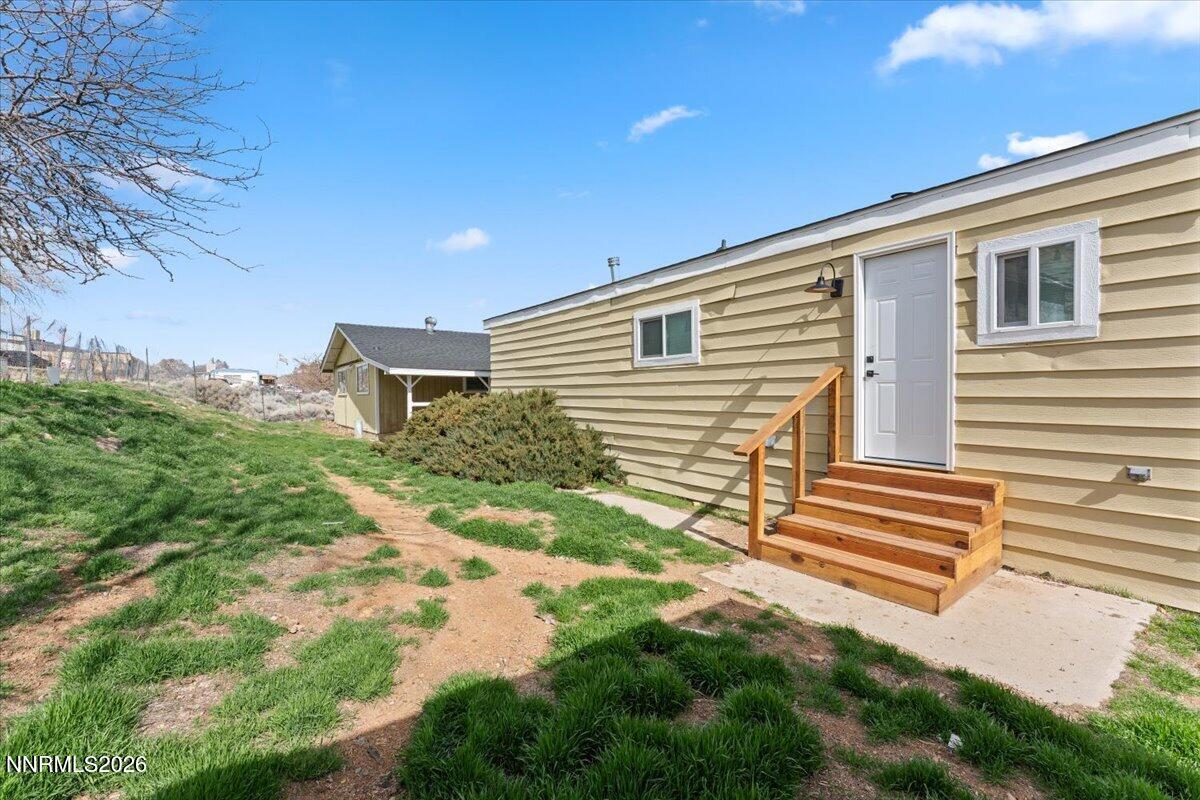 384 Loster Way Sun Valley, NV 89433 - Photo 34 of 35 a front view of a house with garden