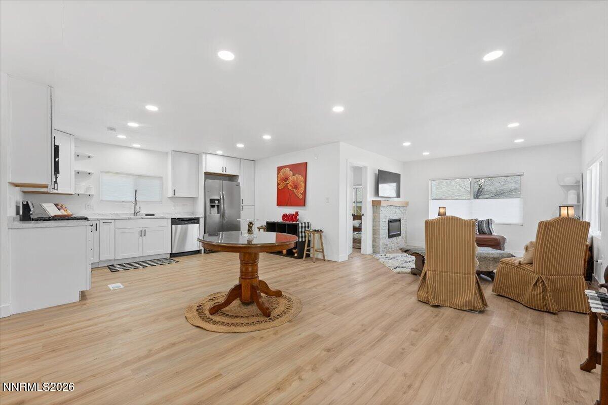 384 Loster Way Sun Valley, NV 89433 - Photo 7 of 35 a living room with furniture a wooden floor and kitchen view