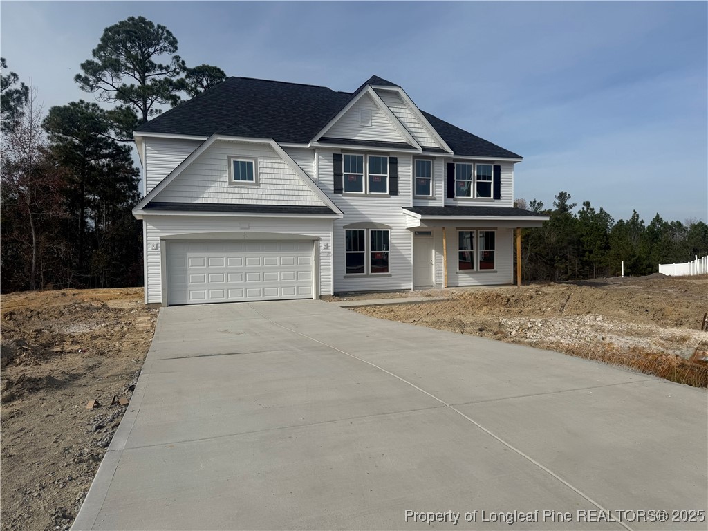 42 Willow Walk Way Cameron, NC 28326 - Photo 2 of 5 a front view of a house with a yard and garage