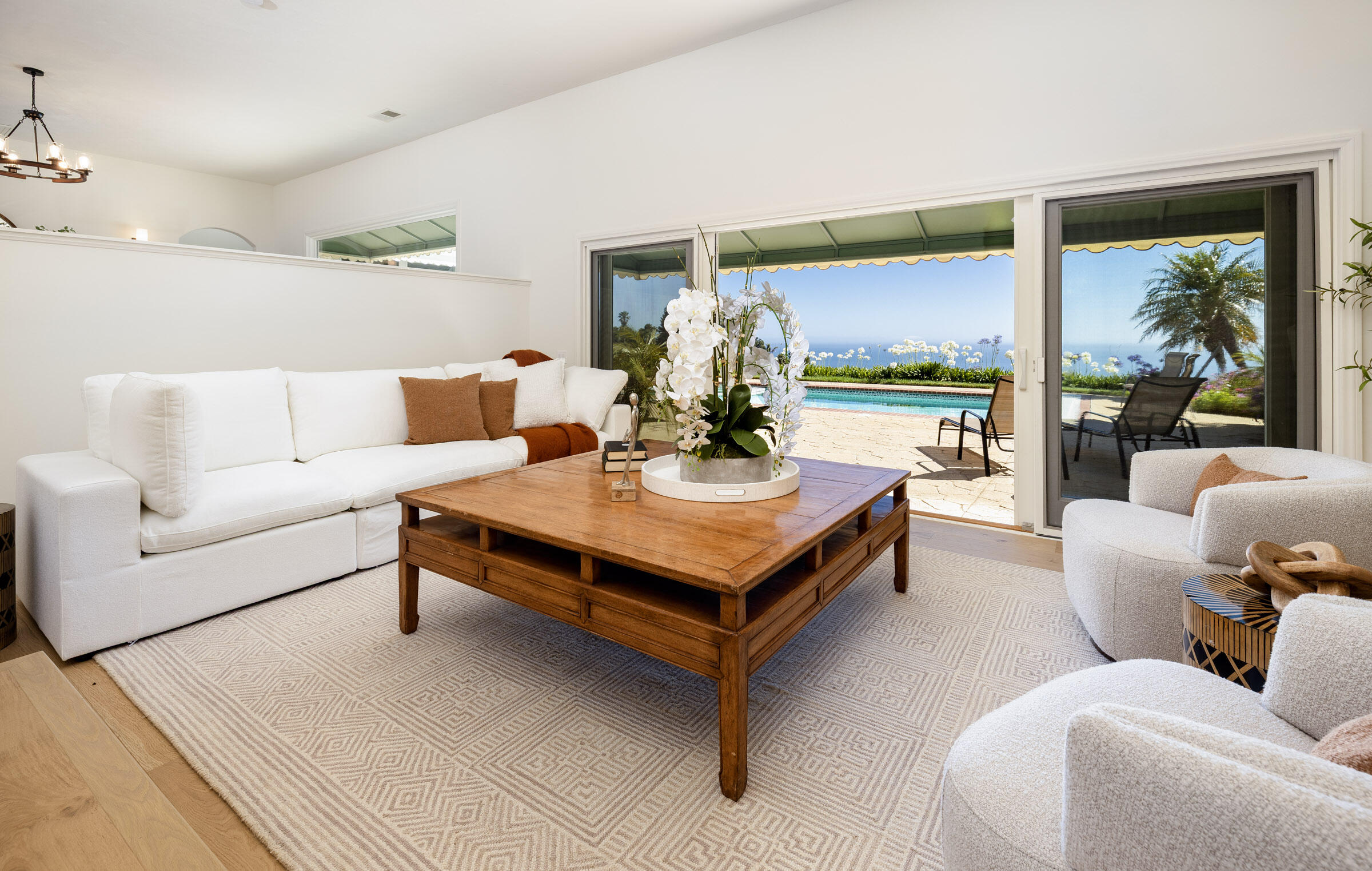 a living room with furniture lamp and large window