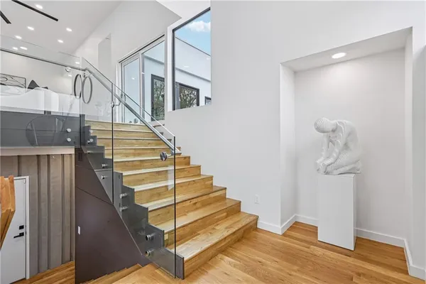 a view of entryway and hall with wooden floor