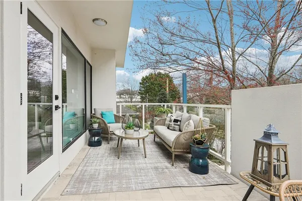 a building outdoor space with patio furniture and potted plants