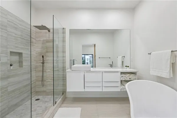 a bathroom with a sink a mirror and a shower