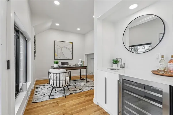 a bathroom with a toilet sink vanity and shower
