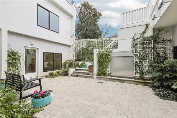 a front view of a building with a garden and plants