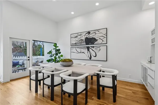 a spacious bathroom with a double vanity sink a mirror and a bathtub