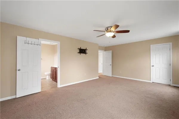 a view of a room with a ceiling fan and a window