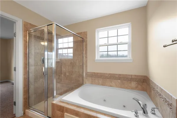a bathroom with a bathtub and shower