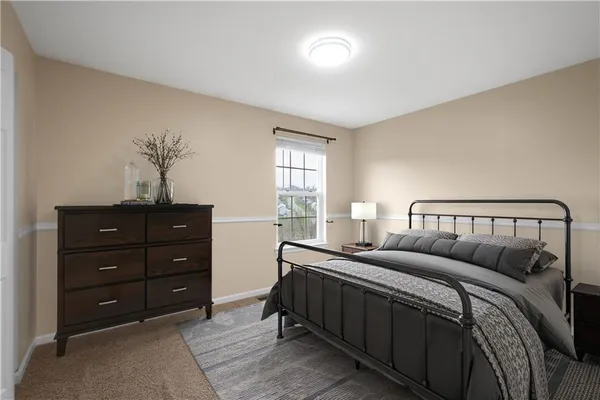 a bedroom with a bed and a potted plant
