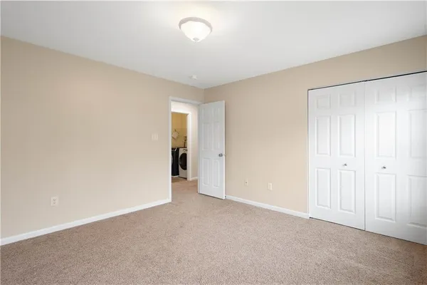a view of an empty room and closet area
