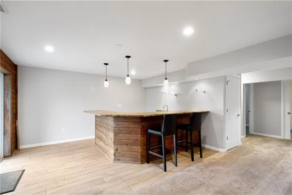 an empty room with wooden floor and furniture