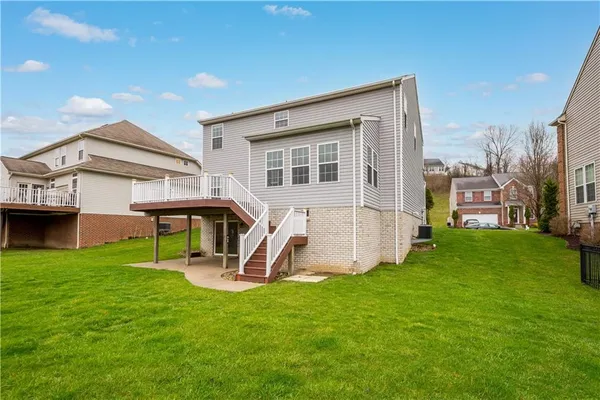 a view of a house with a backyard