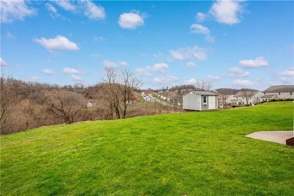 a view of a garden with a building in the background