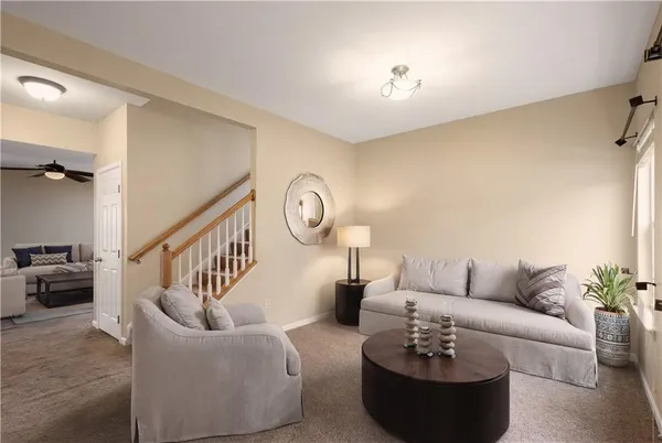 a living room with furniture and a chandelier