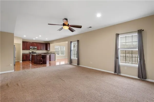a view of a livingroom with furniture and a ceiling fan