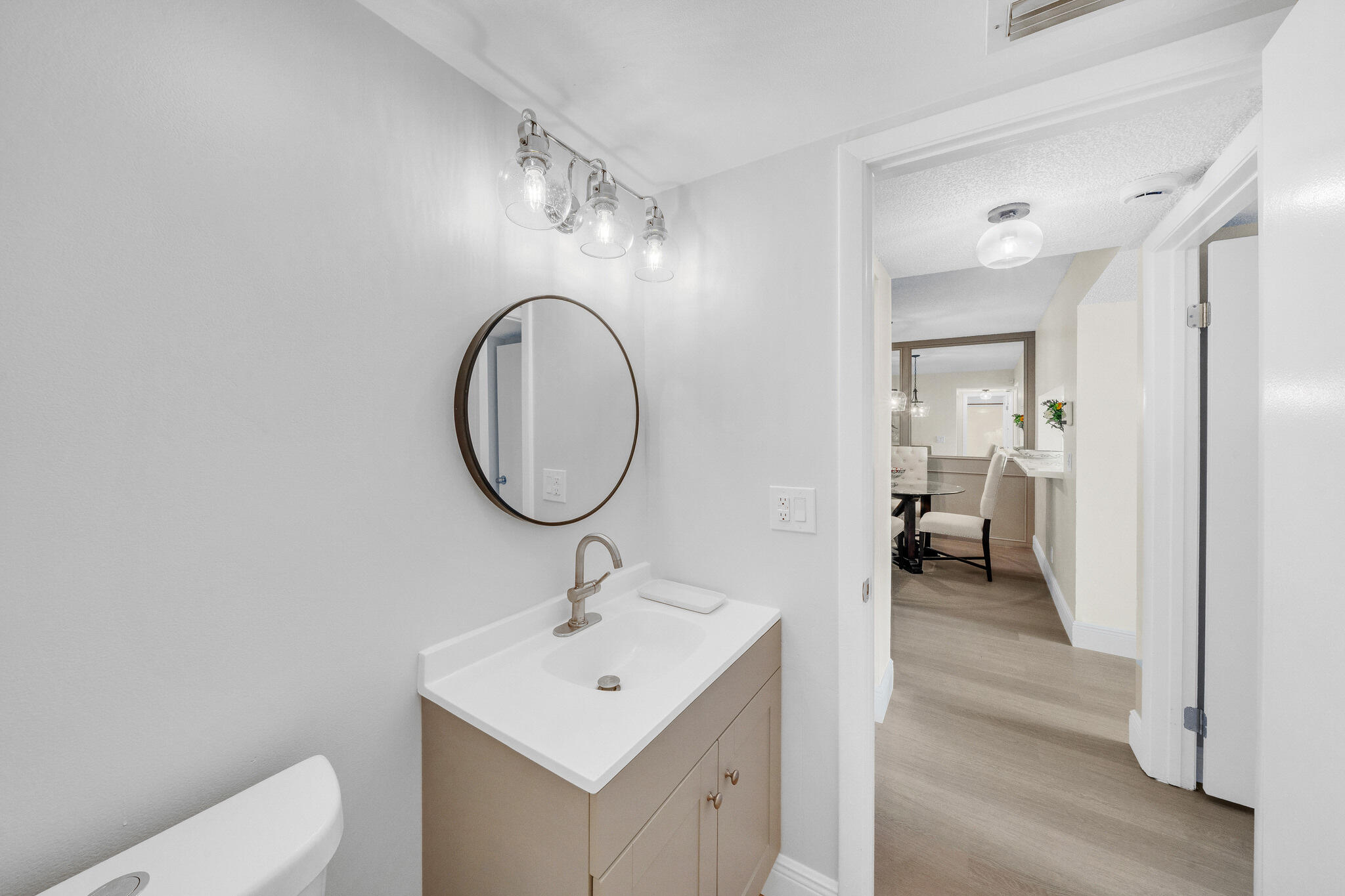 22136 Palms Way, Unit 103 Boca Raton, FL 33433 - Photo 31 of 42 a bathroom with a toilet a sink and mirror