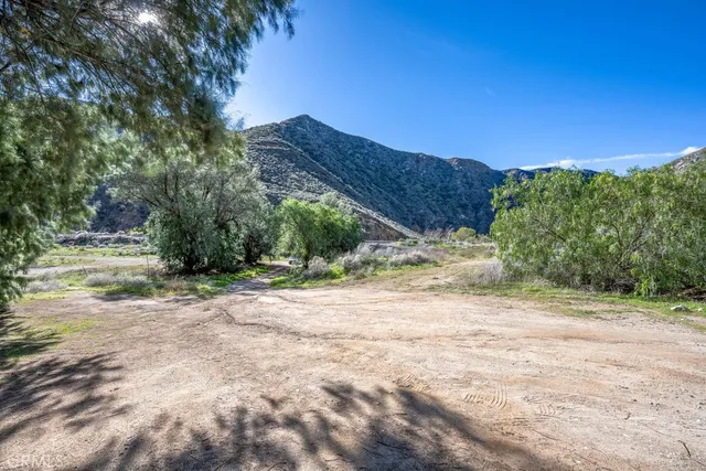 a view of a field with mountains in the background