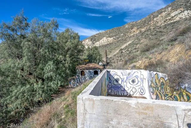 a view of a dry yard with mountain view