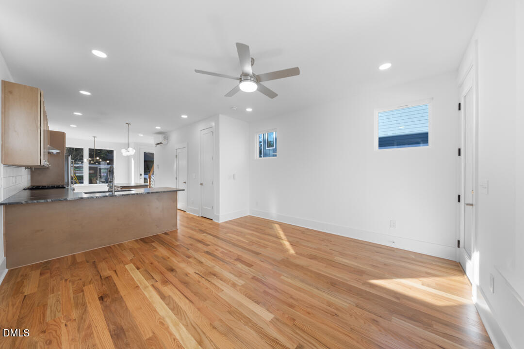 2530 West Wilson Street Durham, NC 27705 - Photo 22 of 49 a view of kitchen with kitchen island wooden floor center island and stainless steel appliances